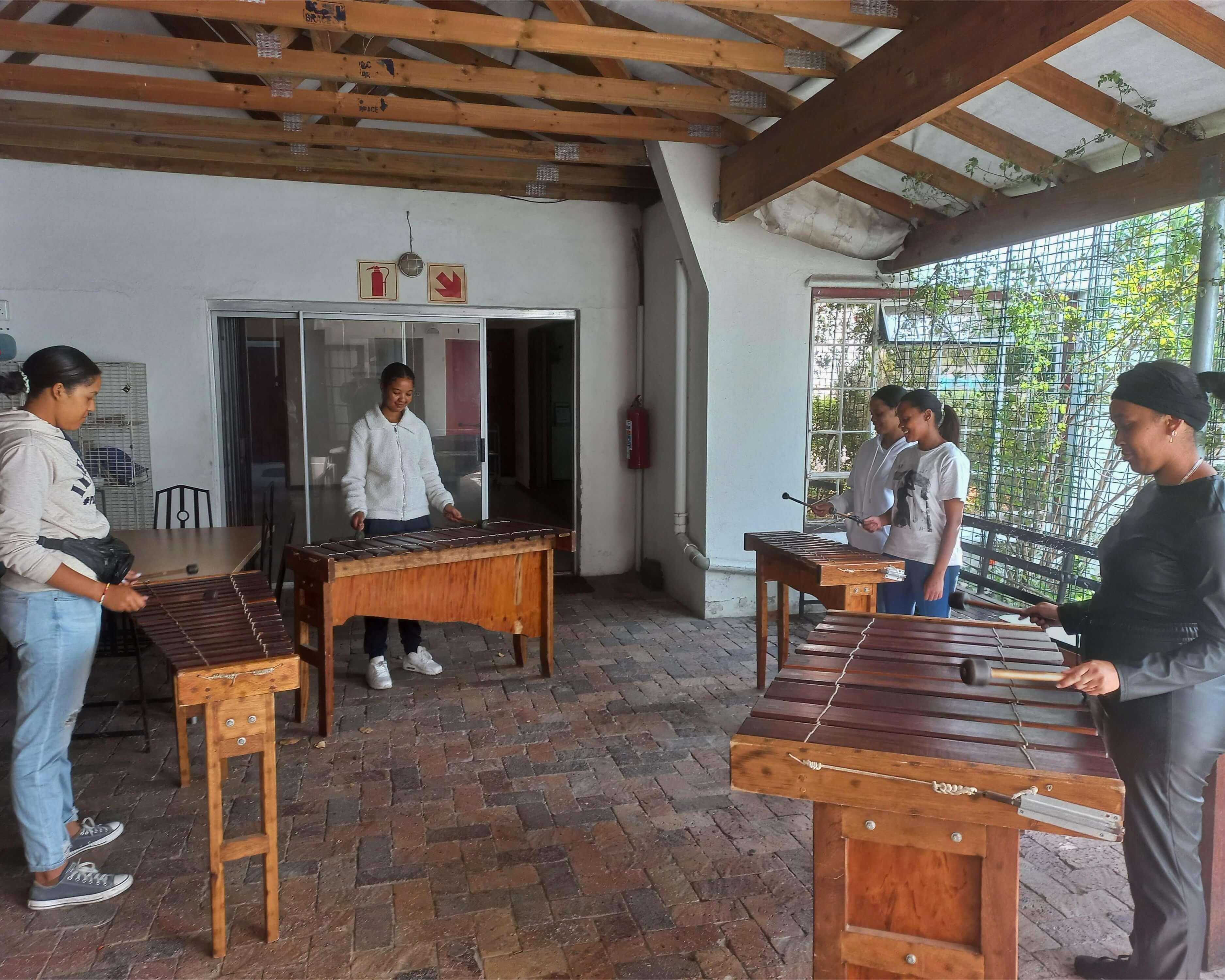 A group of women playing marimbas